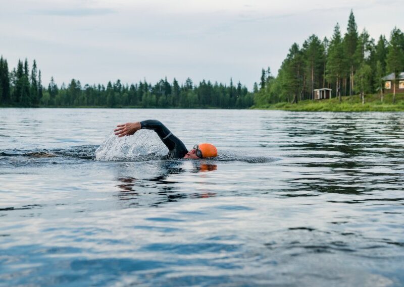 Person swimming in lake